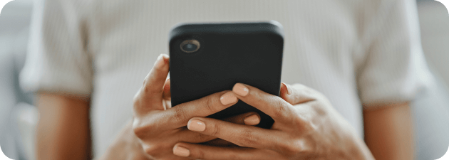RipSIM Contact Where to Reach Us A person holding a smartphone with contact information displayed on the screen.