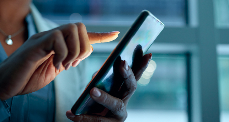 A person interacts with a smartphone, highlighting the modern eSIM technology for RipSIM Home Redefining.